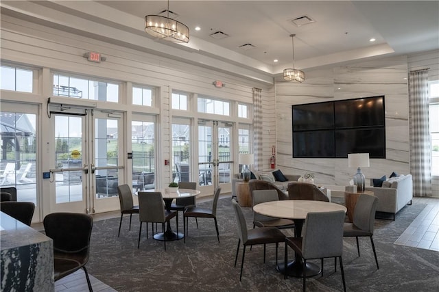dining area featuring french doors, recessed lighting, and a tray ceiling