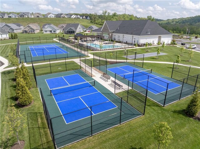 view of tennis court with a residential view
