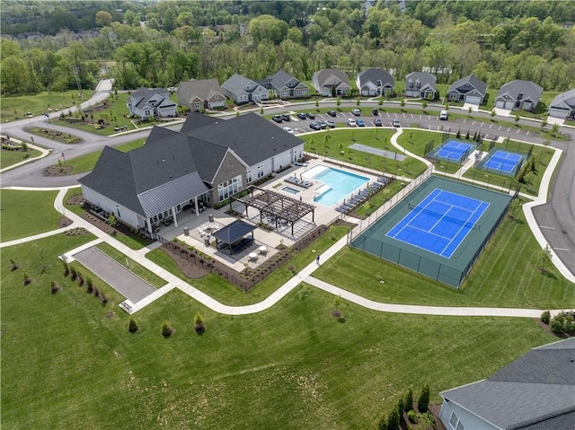 aerial perspective of suburban area featuring a pool