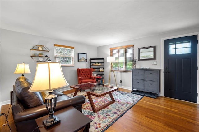 living area with wood finished floors and baseboards