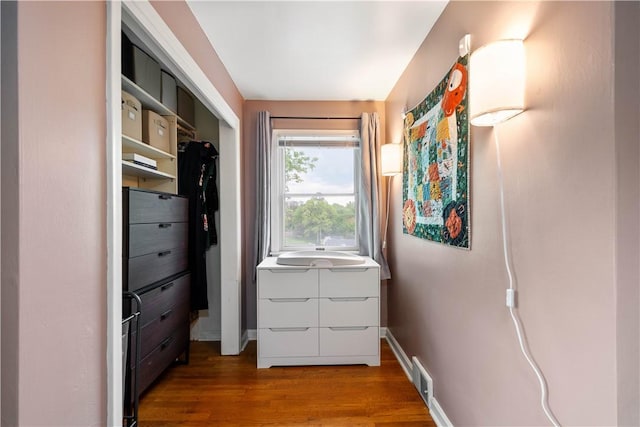 doorway featuring wood finished floors and baseboards