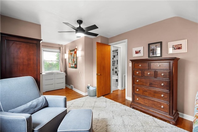 sitting room with baseboards, wood finished floors, and ceiling fan