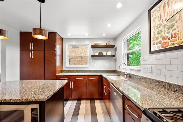 kitchen with stainless steel appliances, a sink, open shelves, tasteful backsplash, and light stone counters