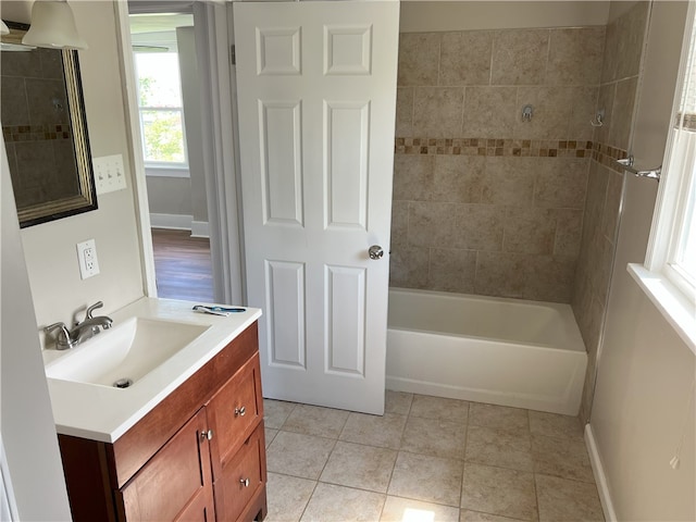 full bath featuring tile patterned floors, vanity, and bathing tub / shower combination