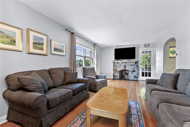 4030 Dalewood St, Brentwood, PA 15227 - living area featuring arched walkways, light wood-style flooring, a fireplace, and baseboards