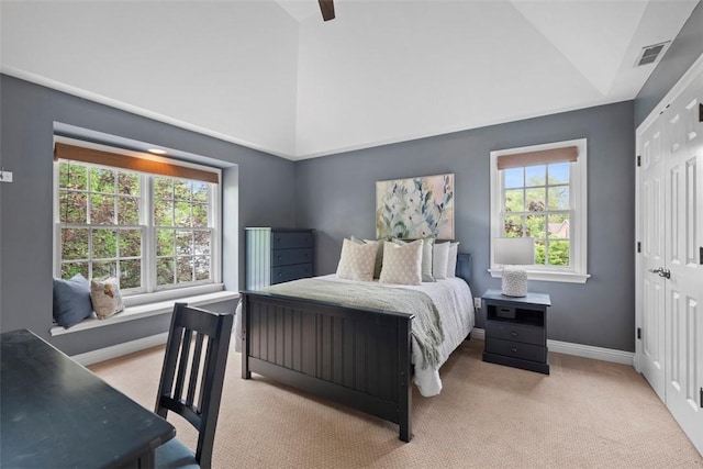 bedroom featuring carpet flooring, baseboards, ceiling fan, a closet, and high vaulted ceiling