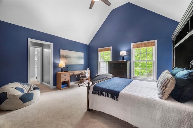 carpeted bedroom featuring a desk, a ceiling fan, baseboards, and high vaulted ceiling