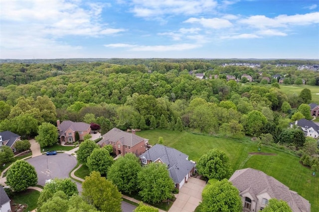 aerial view of residential area featuring a heavily wooded area