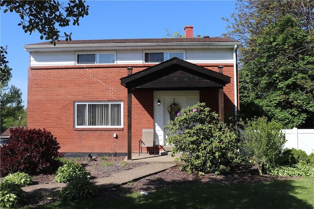 200 Burch Dr, Moon/Crescent Twp, PA 15108 - view of front facade with brick siding, a chimney, and fence