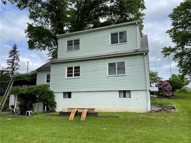 back of property featuring a yard