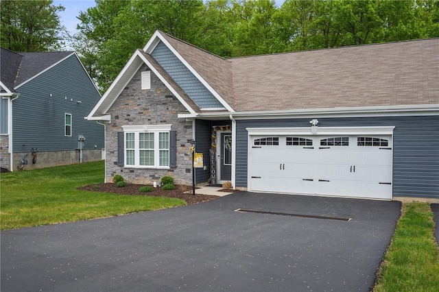 craftsman-style house with a garage, stone siding, asphalt driveway, a front yard, and a shingled roof