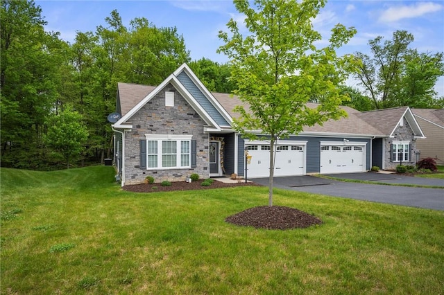 view of front of house with a garage, stone siding, a front yard, and asphalt driveway