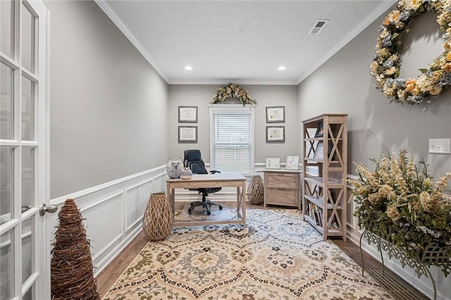 office with wood finished floors, ornamental molding, recessed lighting, and a wainscoted wall