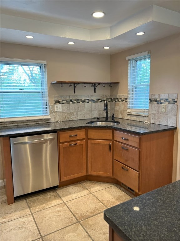 kitchen featuring stainless steel dishwasher, open shelves, a sink, recessed lighting, and tasteful backsplash