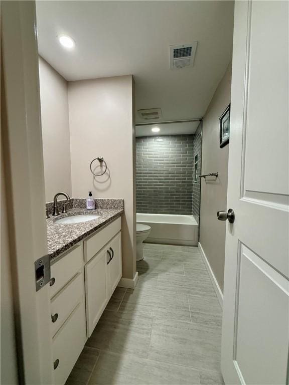 full bath featuring toilet, baseboards, vanity, tile patterned flooring, and shower / bath combination