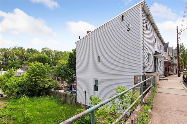 view of side of home featuring a chimney