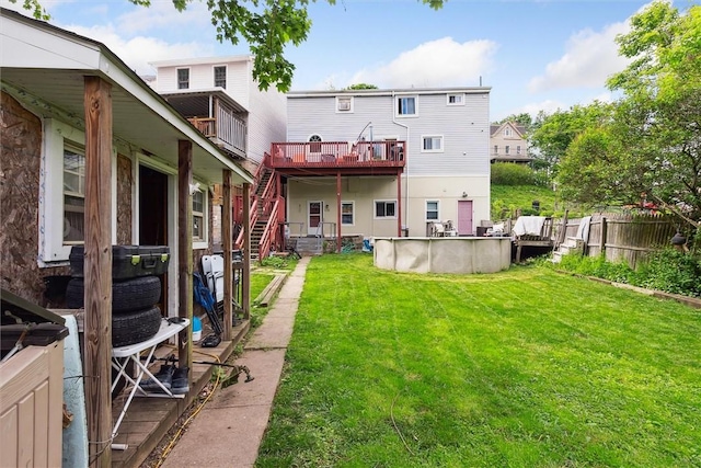 rear view of property featuring stairway and a deck