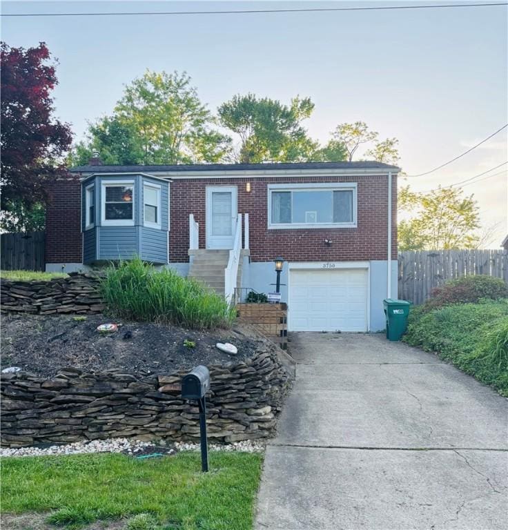 3750 Margate Rd, Churchill Boro, PA 15221 - view of front of home with concrete driveway, fence, a garage, and brick siding