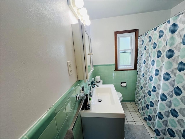 3750 Margate Rd, Churchill Boro, PA 15221 - full bathroom with tile patterned floors, tile walls, vanity, wainscoting, and toilet