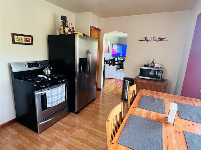 3750 Margate Rd, Churchill Boro, PA 15221 - kitchen with appliances with stainless steel finishes, light wood-style floors, and arched walkways