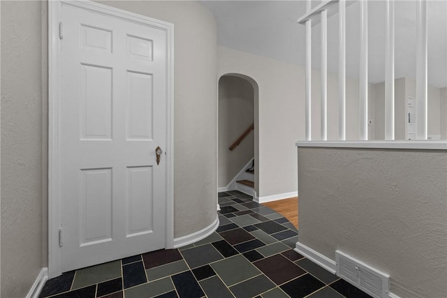 202 Pickwick Dr, Bethel Park, PA 15102 - corridor featuring baseboards, arched walkways, and stairway