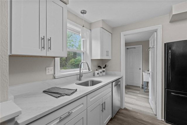202 Pickwick Dr, Bethel Park, PA 15102 - kitchen with freestanding refrigerator, a sink, dishwasher, white cabinetry, and pendant lighting