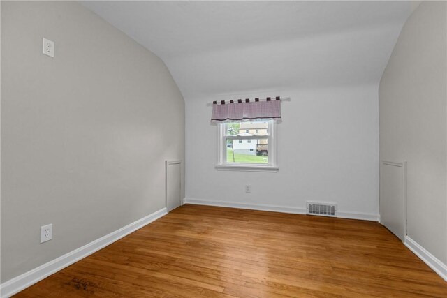 202 Pickwick Dr, Bethel Park, PA 15102 - empty room featuring lofted ceiling, wood finished floors, and baseboards