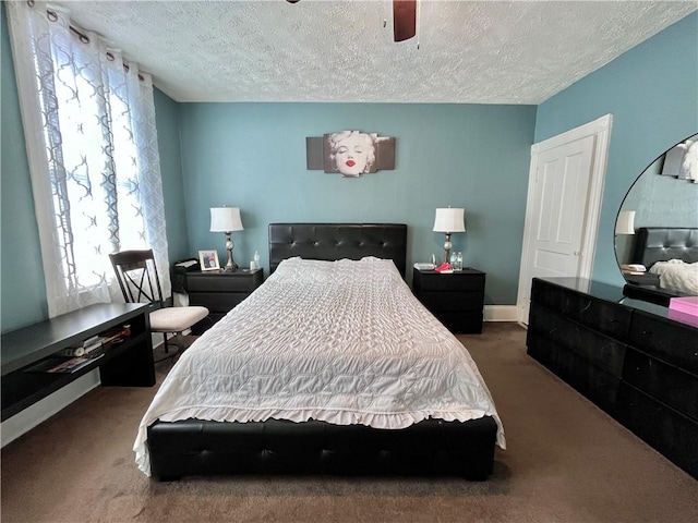bedroom with carpet, a textured ceiling, a ceiling fan, and baseboards