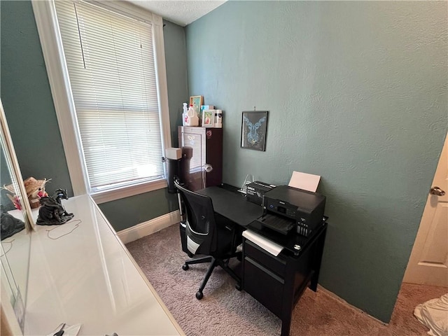 carpeted office space with baseboards