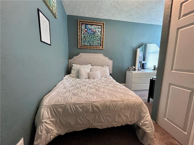 carpeted bedroom featuring a textured ceiling