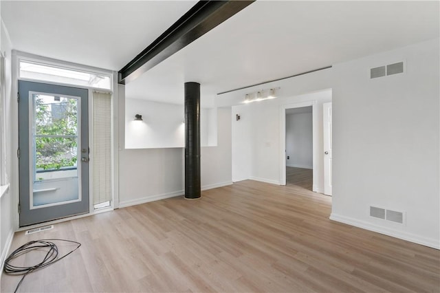 foyer entrance featuring light wood-style flooring and baseboards