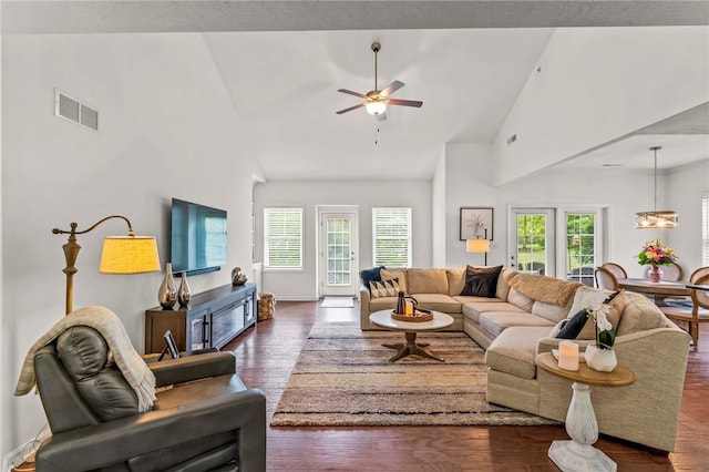 living room featuring dark wood-style floors, a ceiling fan, and high vaulted ceiling