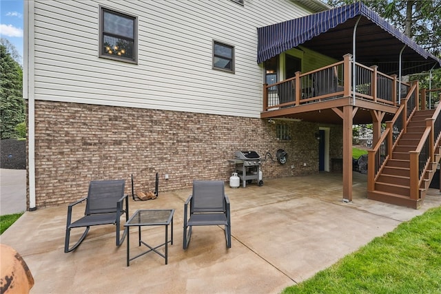 view of patio featuring stairway, area for grilling, and a wooden deck