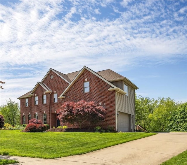 view of front facade with brick siding, concrete driveway, a garage, and a front yard