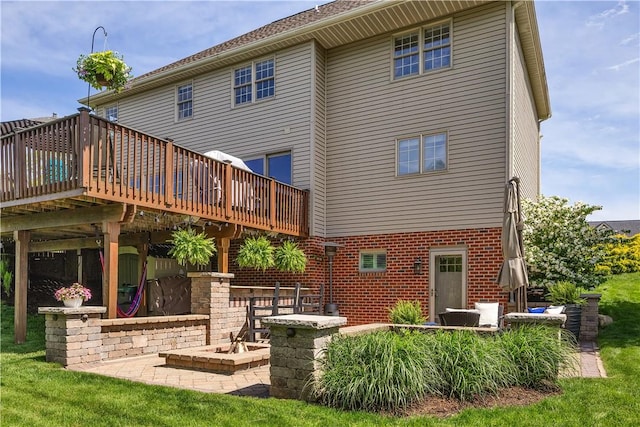 rear view of house featuring a wooden deck, a patio area, and brick siding