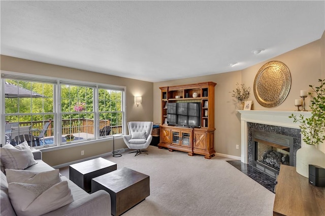 living room with carpet flooring, a fireplace, and baseboards