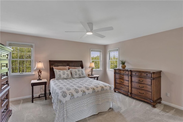 bedroom with carpet flooring, multiple windows, and baseboards