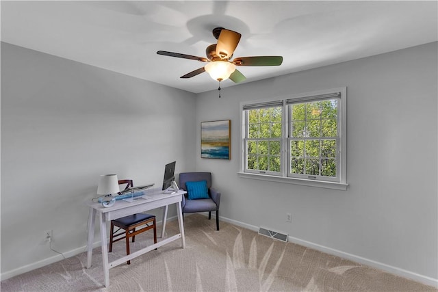 office with a ceiling fan, baseboards, and carpet