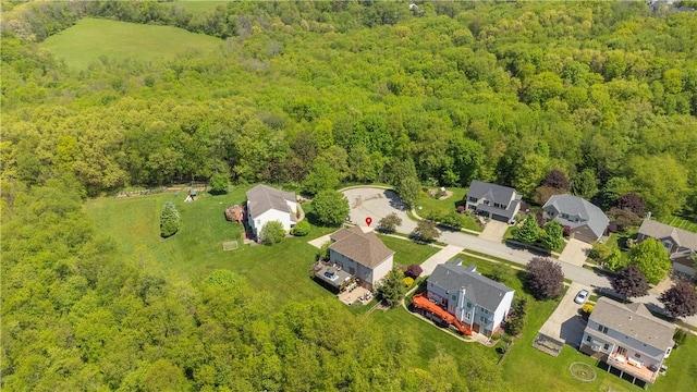 aerial view of residential area featuring a heavily wooded area