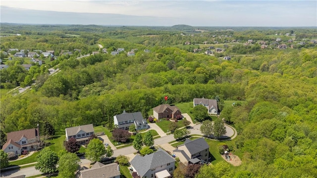 aerial view of residential area featuring a heavily wooded area