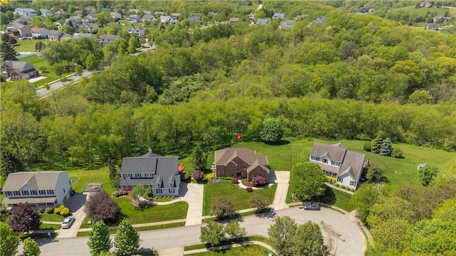 aerial perspective of suburban area featuring a heavily wooded area