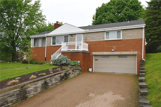 5005 Brownsville Rd, Whitehall, PA 15236 - view of front of property featuring an attached garage, decorative driveway, a chimney, brick siding, and a front yard