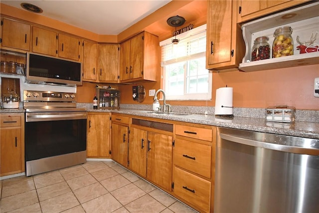 5005 Brownsville Rd, Whitehall, PA 15236 - kitchen with stainless steel appliances, a sink, light tile patterned floors, and brown cabinets
