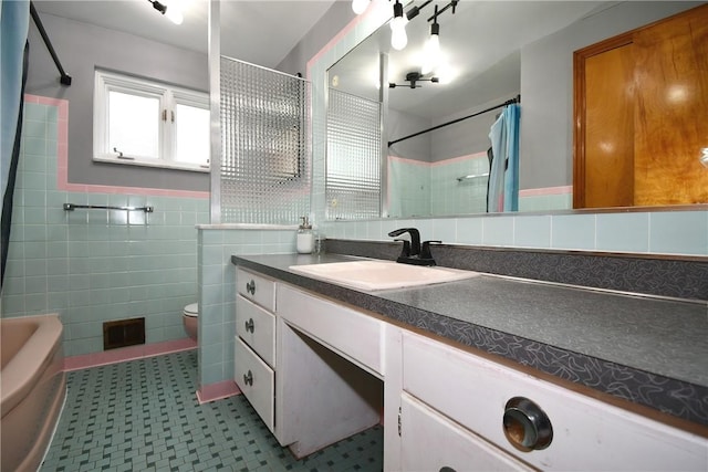 5005 Brownsville Rd, Whitehall, PA 15236 - bathroom featuring toilet, tile walls, wainscoting, vanity, and tile patterned floors