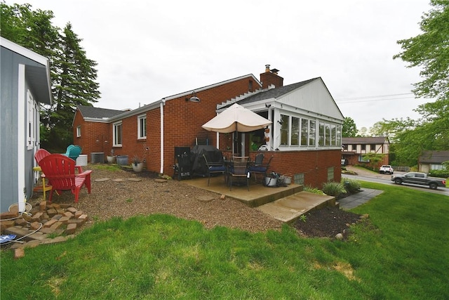 5005 Brownsville Rd, Whitehall, PA 15236 - back of house with brick siding, central AC, a yard, and a patio