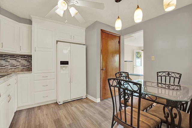 1409 Gill Hall Rd, Jefferson Hills, PA 15025 - kitchen with white refrigerator with ice dispenser, a ceiling fan, light wood finished floors, backsplash, and white cabinetry