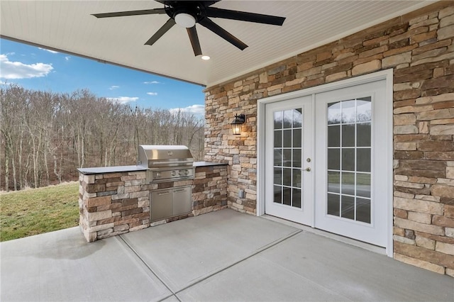 view of patio featuring french doors, an outdoor kitchen, grilling area, and a ceiling fan