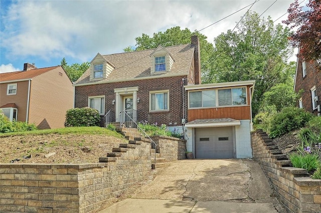 338 Elizabeth Ave, Chalfant Boro, PA 15112 - cape cod home with brick siding, driveway, a chimney, a garage, and a shingled roof