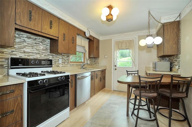 338 Elizabeth Ave, Chalfant Boro, PA 15112 - kitchen with appliances with stainless steel finishes, plenty of natural light, a sink, and decorative backsplash