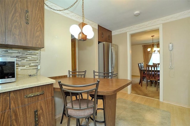 338 Elizabeth Ave, Chalfant Boro, PA 15112 - dining area with a chandelier, light wood-style flooring, and baseboards